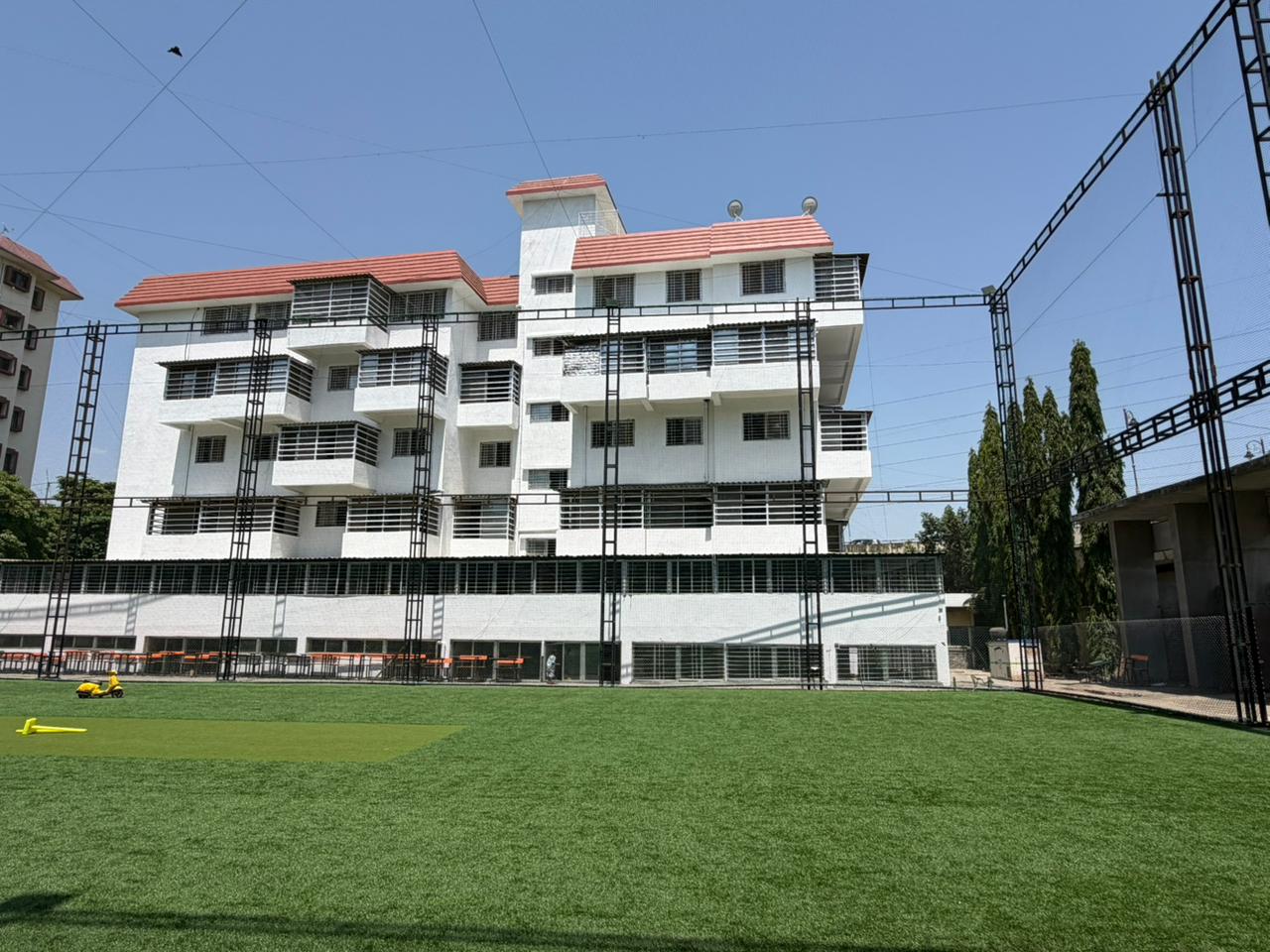 School building rear view with sports ground